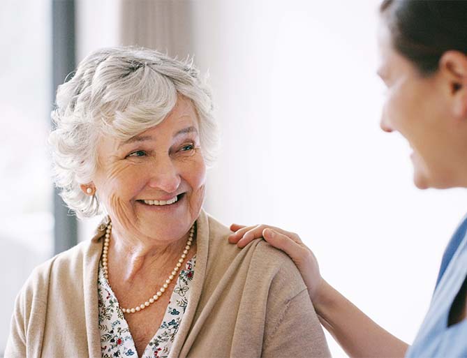 woman smiling with nurse