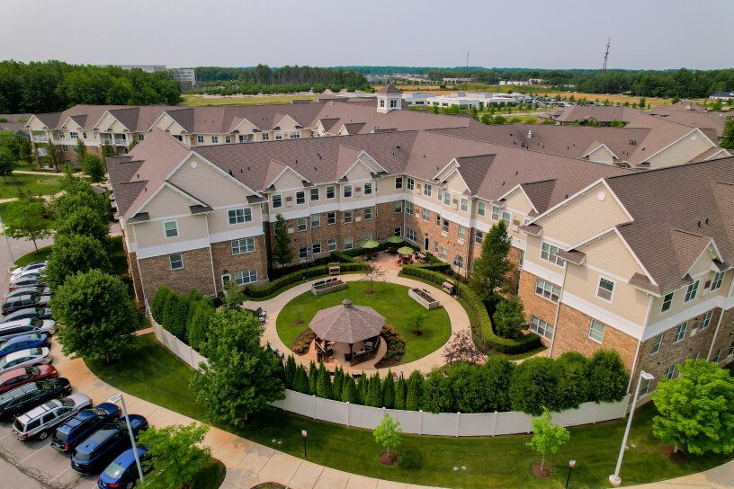 Aerial view of a residential complex with central courtyard and surrounding landscaped areas.