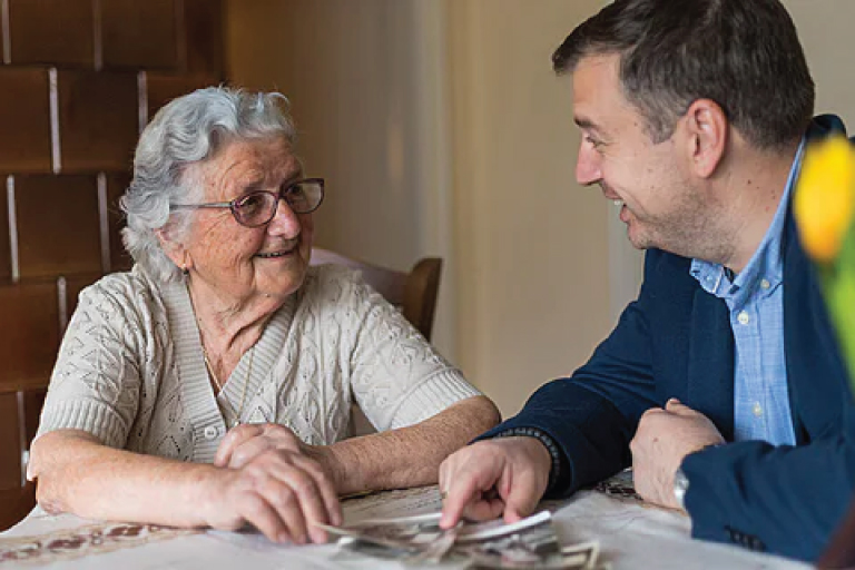 Senior woman talking to man