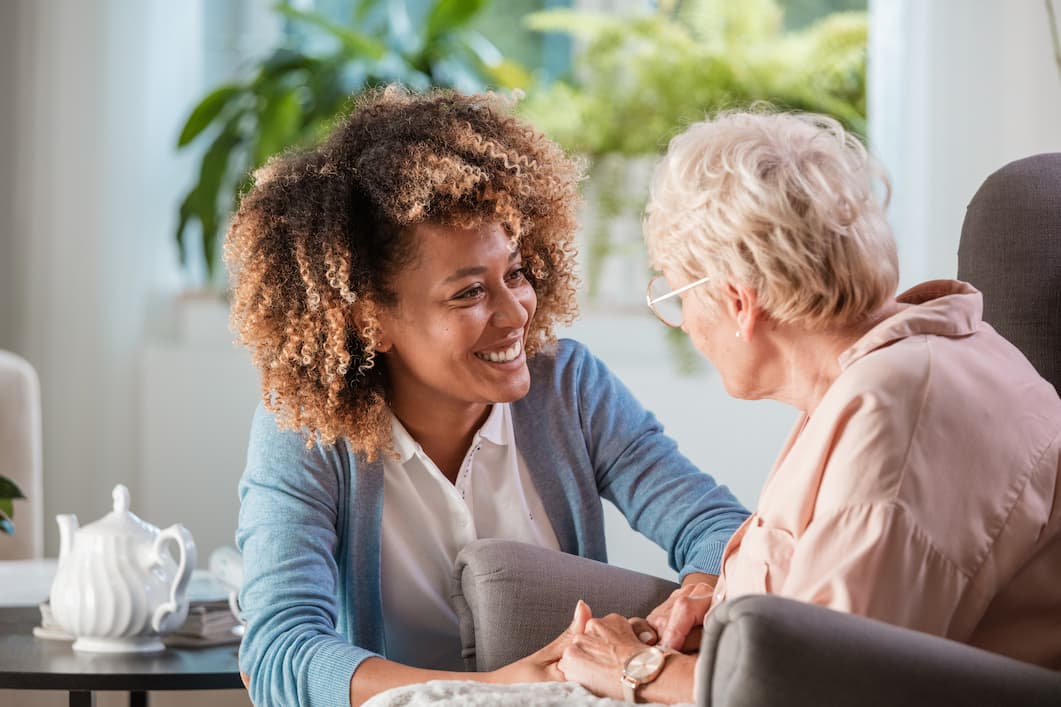 Senior woman speaking to adult woman